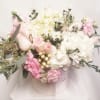Pink and white bouquet in a round box with a ribbon