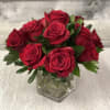 Red roses arranged in a clear glass vase