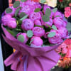 Pink peony bouquet wrapped in magenta paper with eucalyptus