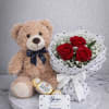 Three red roses tucked into a compact bouquet make an immediate, romantic