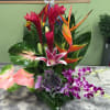 Tropical flower arrangement with orchids, anthuriums, and bird of paradise