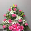 Bright pink roses paired with creamy white lilies create a lush, feminine