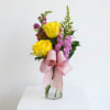 Two bright yellow roses set the tone in this cheerful flower arrangement