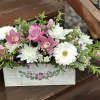 A decorative spring box filled with roses, Gerbera daisies, &amp; chrysanthemums. Suitable