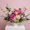 A lush garden inspired Mother's Day arrangement designed in a classic white
