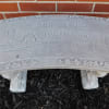 Stone sign reading welcome to the farm with a tractor and barn design