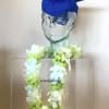Glass bust wearing a blue graduation cap and a white-green flower lei