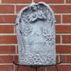 Gray memorial plaque with angel relief and the words In Loving Memory
