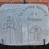 Memorial plaque with a farm scene and the words 'In Loving Memory of a Farmer'