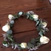 White rose floral crown with eucalyptus and small purple filler flowers