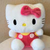 Hello Kitty plush toy with a pink bow and outfit