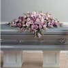 Pink floral casket spray with lilies and roses