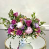 A full, low-spreading bouquet of lavender roses and pale peonies creates a