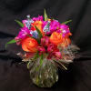 Bouquet of orange roses and magenta flowers wrapped in clear plastic