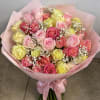 This bouquet features a blend of blush pink, warm peach, and buttery