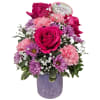 Three beautiful hot pink roses surrounded by lavender daisies and baby's breath