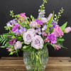 The bouquet features a harmonious blend of textures and heights, presented in