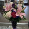 Gathered mix of pink lilies, blush roses, carnations, alstroemeria and daisies in
