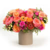 A lush mix of apricot, peach and pink blooms styled with fresh