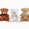 Three teddy bears with polka-dot bows sit side by side.