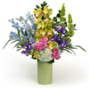 A stunning arrangement with vibrant blue blooms and fresh greens with soft