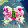 Butterfly-shaped floral arrangement with pink roses and white lilies