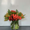 Shades and textures of orange arranged in modern clusters of tulips, roses