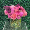 Pink and purple flower arrangement in a clear glass vase