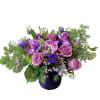 Purple and pink floral arrangement in a dark vase