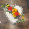 Heart-shaped lace pillow with a colorful floral garland