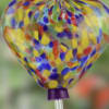 Attract the hummingbirds with this multi-color glass heart single-feed hummingbird feeder. This