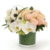 Delicate white and blush blooms with fresh greenery creating a soft, refined