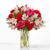 Bright pink roses and vibrant red carnations combine with pale pink alstroemeria