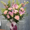 Pink lilies, roses, carnations, and snapdragons in pink shades with fillers 