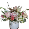A soft and romantic arrangement featuring blush roses, delicate hyacinth, Cymbidium orchids