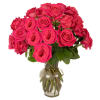 Arrangement of bright pink roses in a clear glass vase with visible stems
