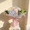 Soft pastel hydrangeas in pink, blue, cream and green, lushly wrapped with