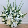 Large white floral arrangement in a woven basket