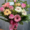 Pink roses and mix colors gerbera daisies with greenery beautifully arranged in