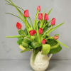 A spray of tulips with long, arching green leaves creates a fresh