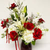 Red roses and white lilies arranged in a dark vase