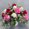 Beautiful designed 16 mixed roses in a white ceramic container. 