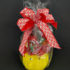 Gift basket wrapped in cellophane with a red heart ribbon and smiley-face container