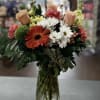 Mixed bouquet of roses, gerbera, carnations, stock and coffee berries in peach
