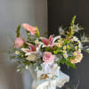 This beautiful flower arrangement of fresh mixed seasonal blooms is made by