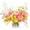A vibrant, whimsical garden-style arrangement featuring lush peonies in pink tones paired