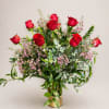 12 long stem red roses arranged in a designer gold bottomed vase