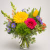 A bright yellow gerbera daisy and a vivid pink rose take center