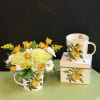 Bright and refreshing floral arrangement in a charming lemon-print mug. Features soft