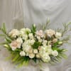 Cream and blush floral arrangement in a white vase
